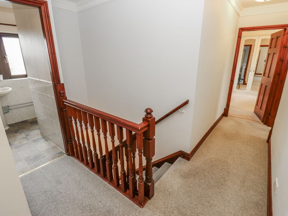 A staircase and hallway with a bathroom visible at The Peak View Holmfirth