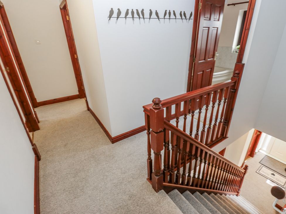A hallway with staircase and doors at The Peak View Holmfirth