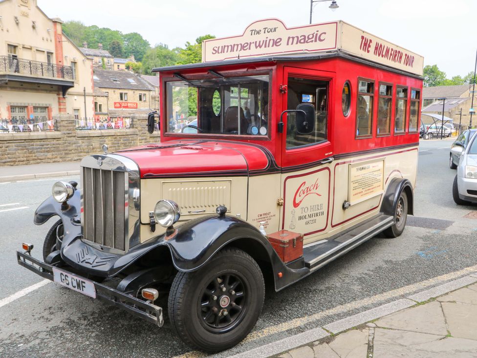A vintage coach parked on the street at The Peak View Holmfirth in Hade Edge, Yorkshire
