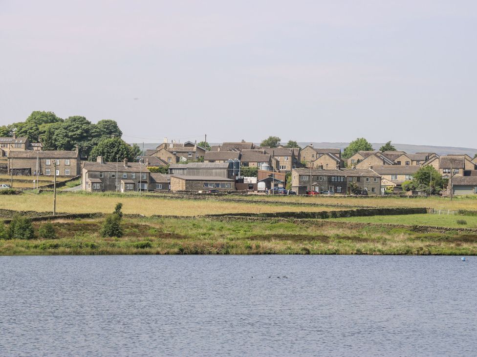 A view of houses beside a body of water at The Peak View Holmfirth Hade Edge, Yorkshire