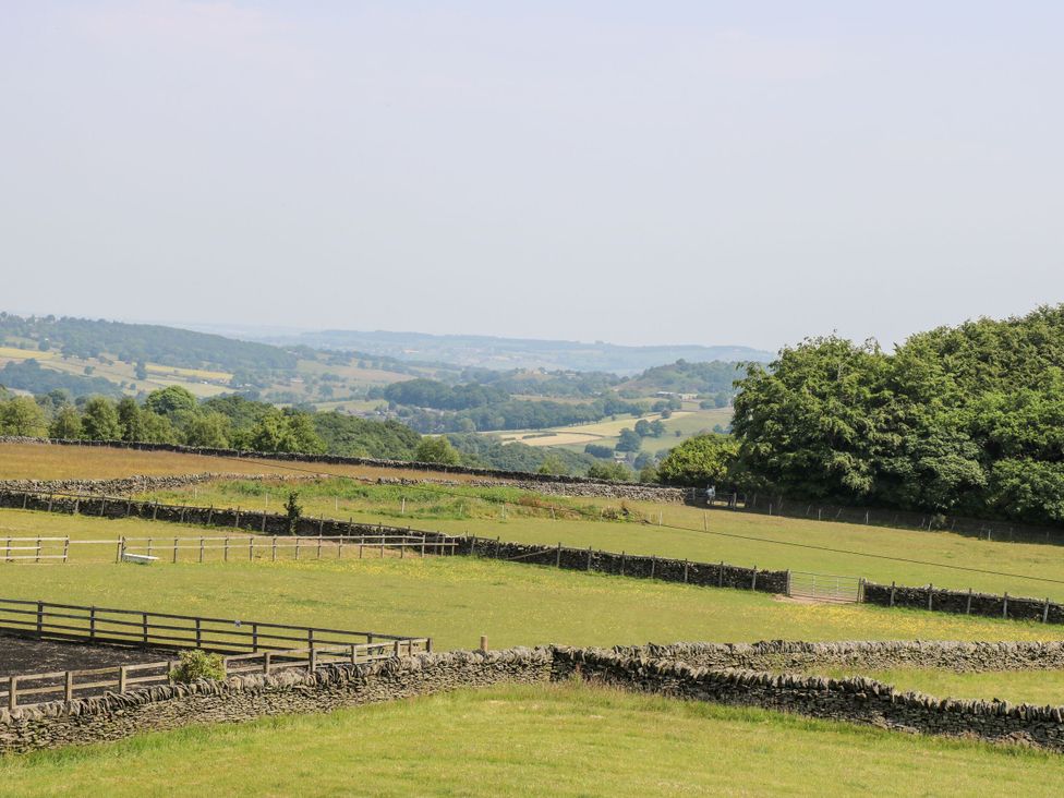 A landscape with fields and stone walls at The Peak View Holmfirth in Hade Edge, Yorkshire