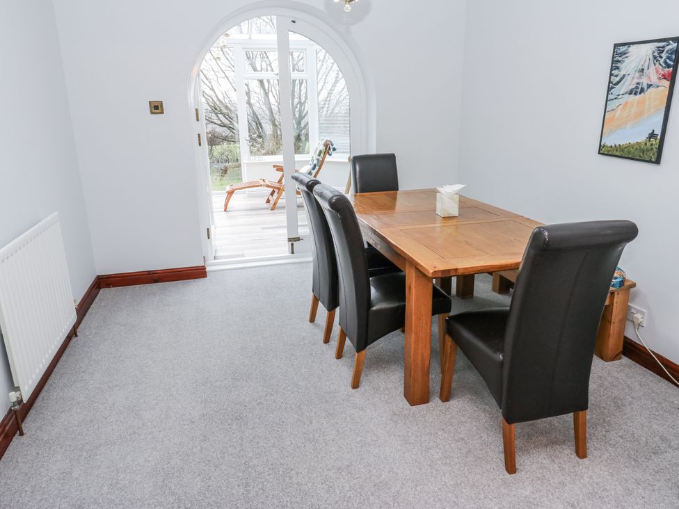 A dining room with a table and chairs at The Peak View Holmfirth in Hade Edge, Yorkshire