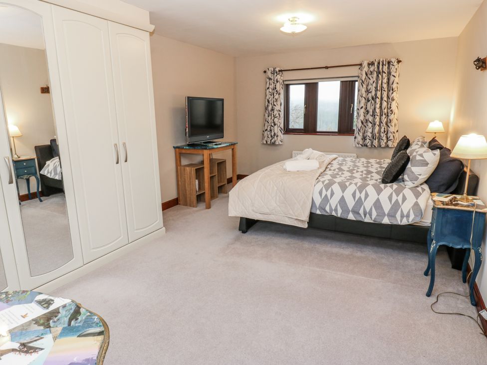 A bedroom with a bed and television at The Peak View Holmfirth Hade Edge, Yorkshire