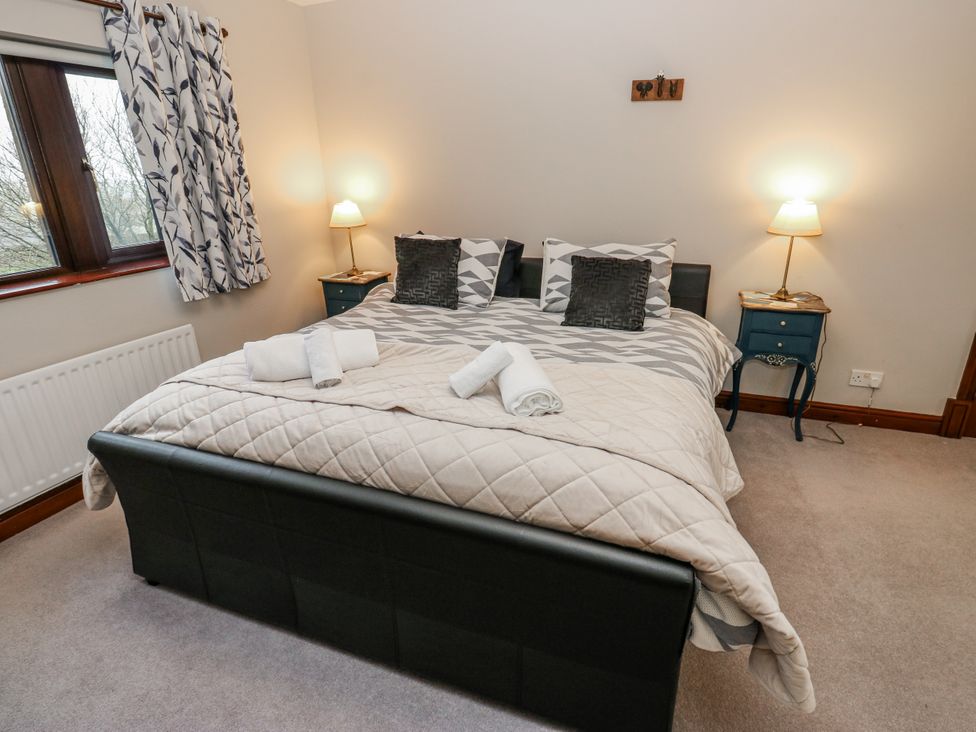 A bedroom with a bed and lamps at The Peak View Holmfirth Hade Edge, Yorkshire