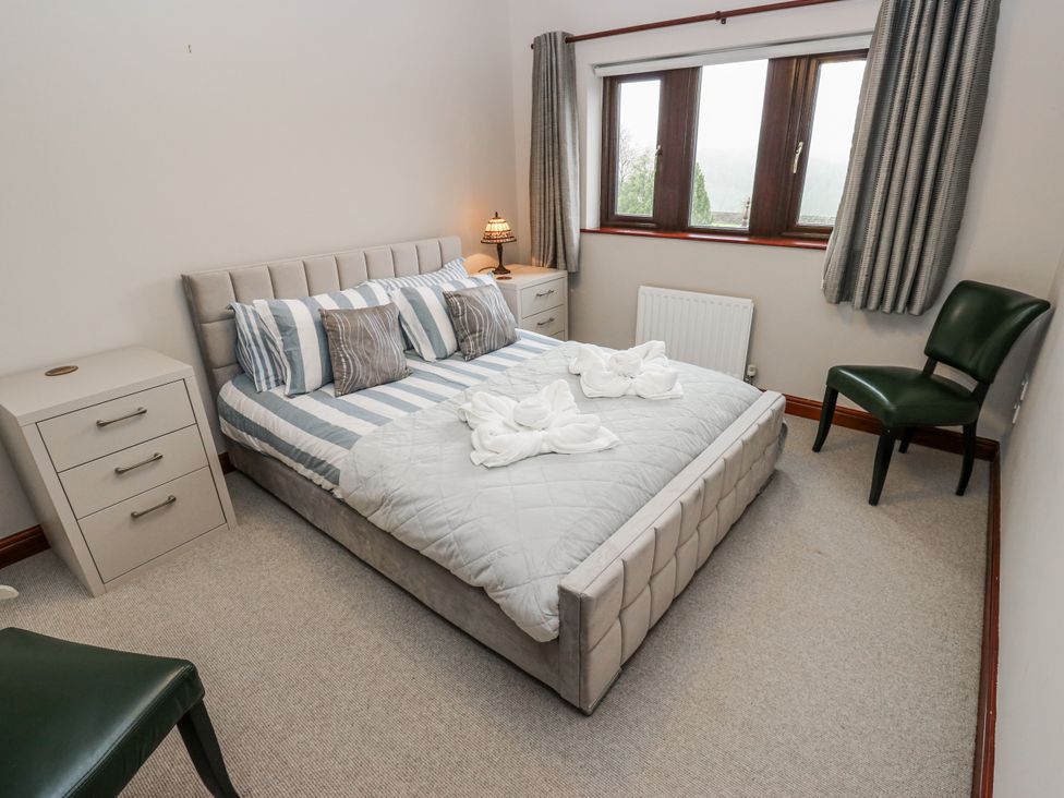 A bedroom with a bed and bedside table at The Peak View Holmfirth Hade Edge, Yorkshire