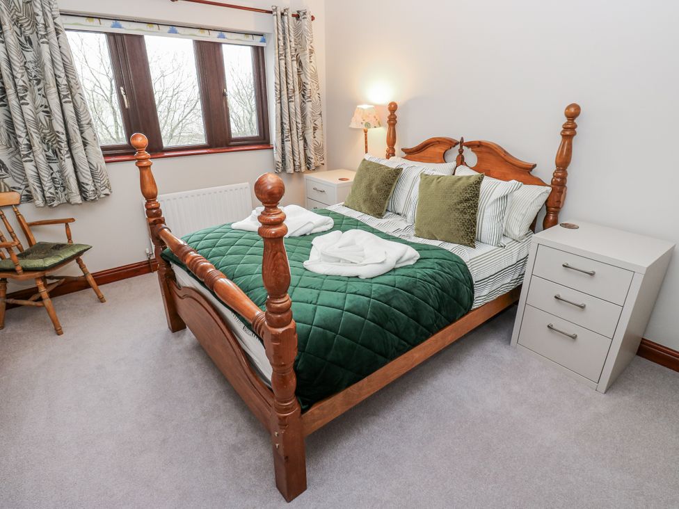 A bedroom with a bed and bedside table at The Peak View Holmfirth in Hade Edge, Yorkshire