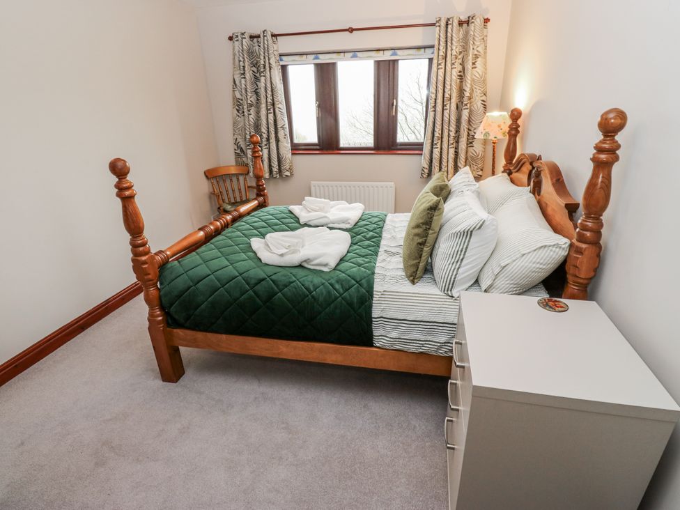 A bedroom with a bed and window at The Peak View Holmfirth in Hade Edge Yorkshire