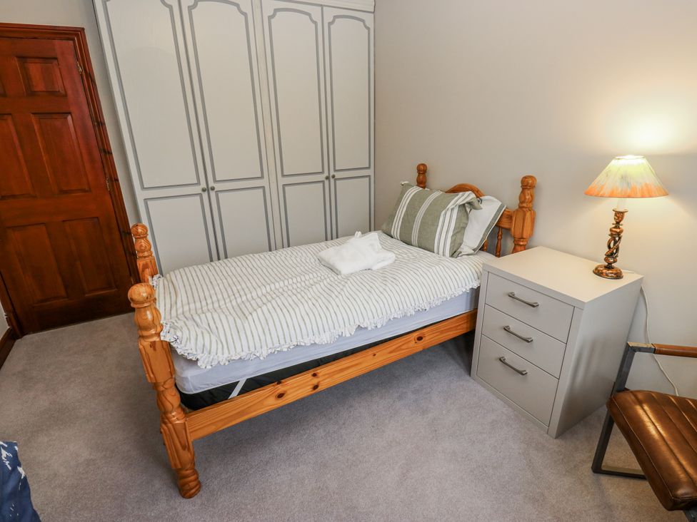 A bedroom with a single bed and a wardrobe at The Peak View Holmfirth Hade Edge, Yorkshire