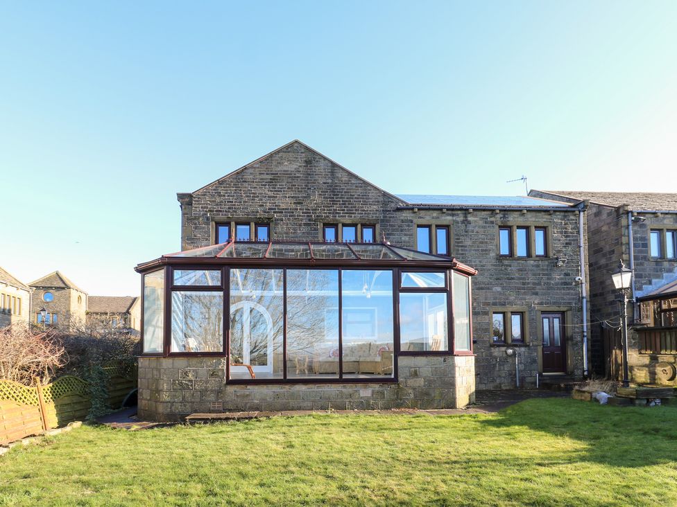 A house with a conservatory in the yard at The Peak View Holmfirth in Hade Edge, Yorkshire