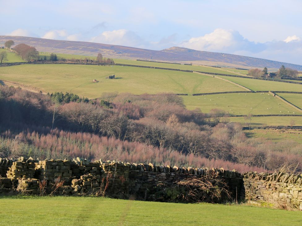 A landscape with stone walls and rolling hills at The Peak View Holmfirth Hade Edge Yorkshire