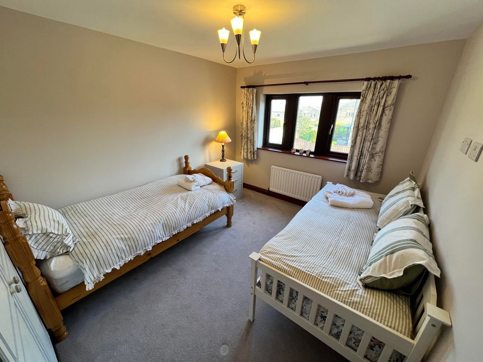 A bedroom with two single beds and a nightstand at The Peak View Holmfirth Hade Edge, Yorkshire