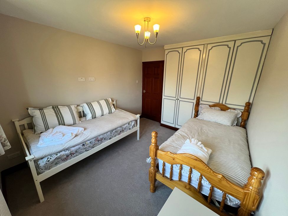 A bedroom with two beds and wardrobe at The Peak View Holmfirth in Hade Edge, Yorkshire