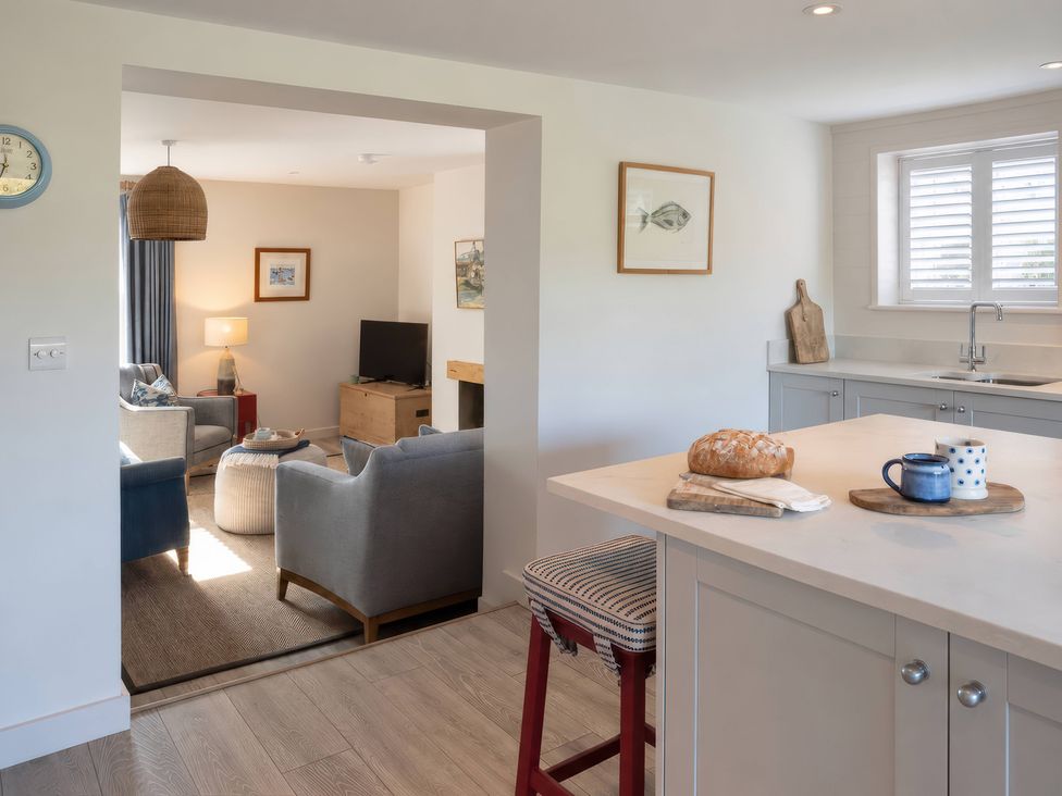 A kitchen with a view of the living area at Wood Cottage