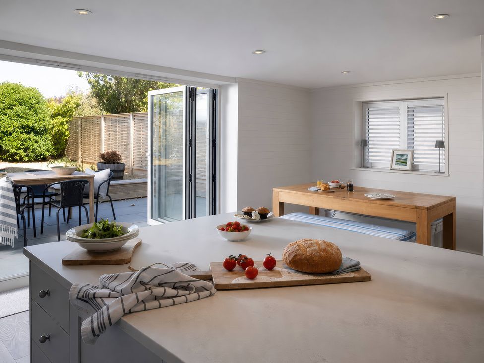 A kitchen with food items and outdoor access at Wood Cottage