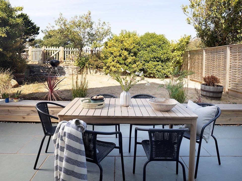 A dining area with a table and chairs at Wood Cottage