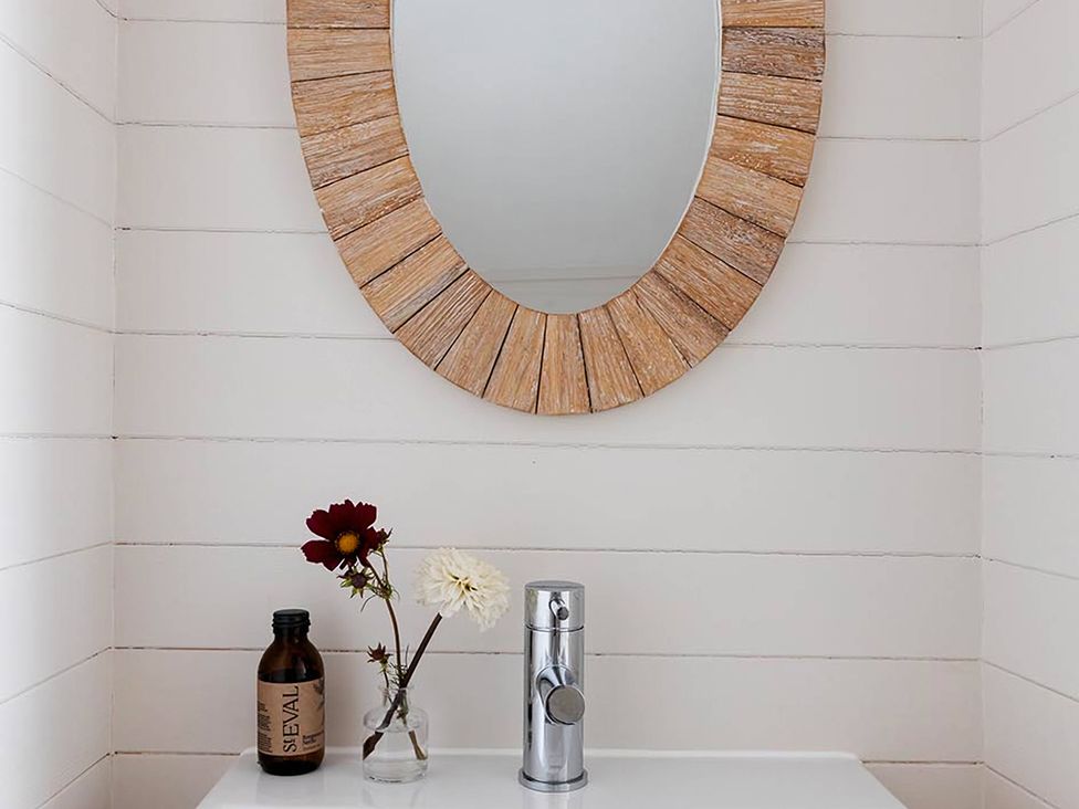 A bathroom with a sink and a mirror at Wood Cottage