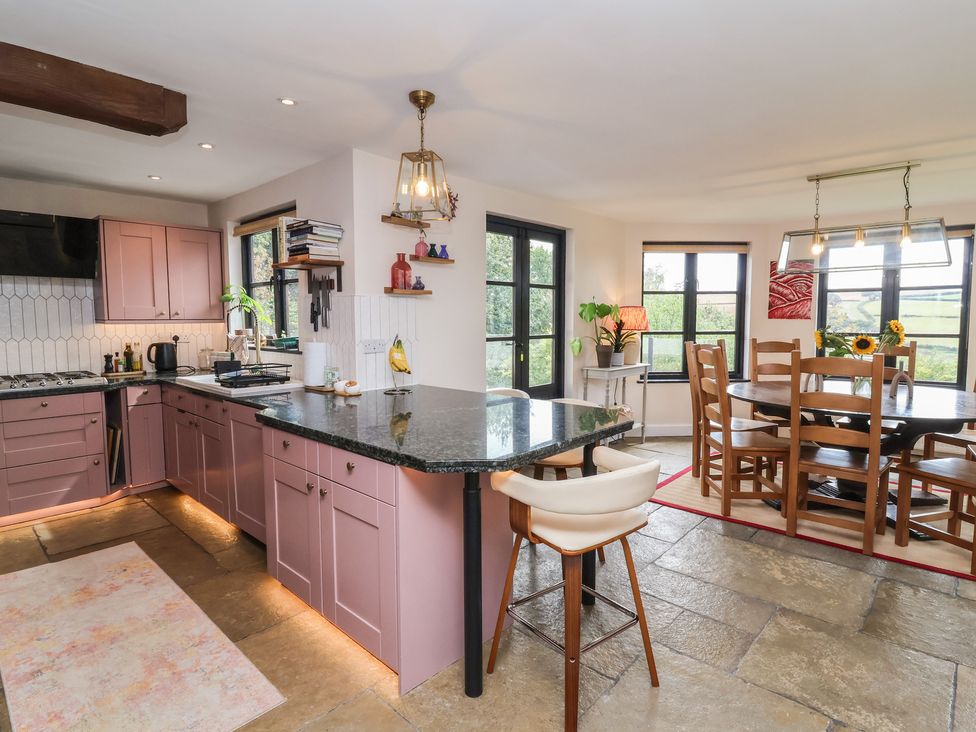 A kitchen with a dining area at Hedgerose in Goodleigh near Barnstaple
