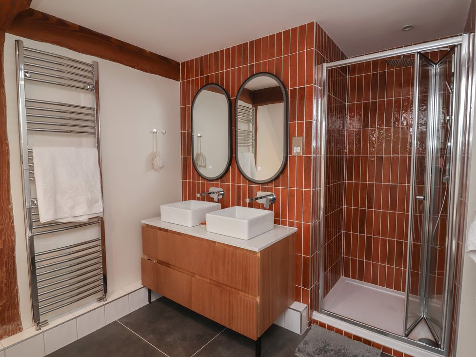 A bathroom with two basins and a shower at Hedgerose in Goodleigh near Barnstaple
