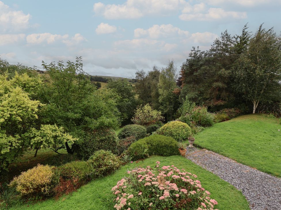 A garden with trees and flowers at Hedgerose Goodleigh near Barnstaple