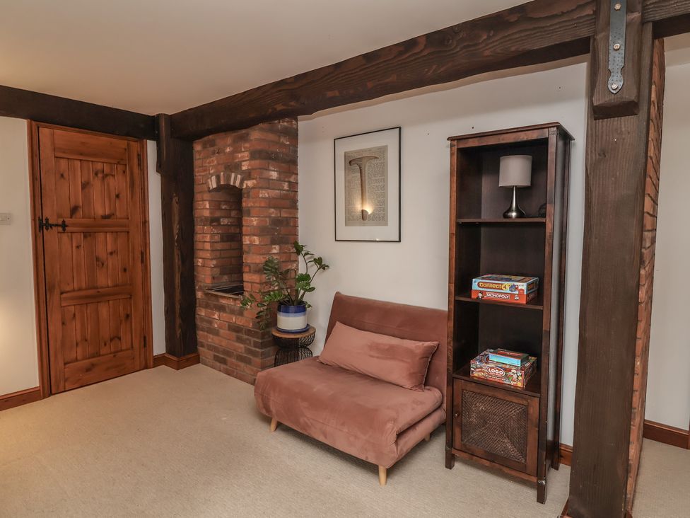 A snug with a sofa and shelf at Hedgerose in Goodleigh near Barnstaple