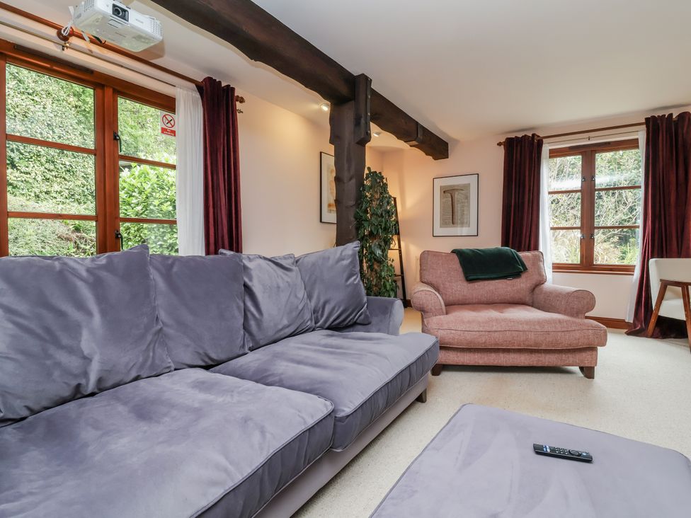 A living room with a sofa and armchair at Hedgerose Goodleigh near Barnstaple
