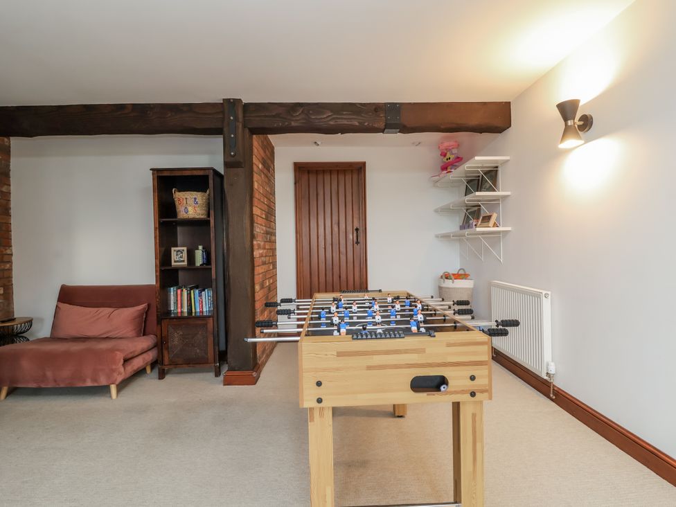 A foosball table and sofa in a snug at Hedgerose Goodleigh near Barnstaple