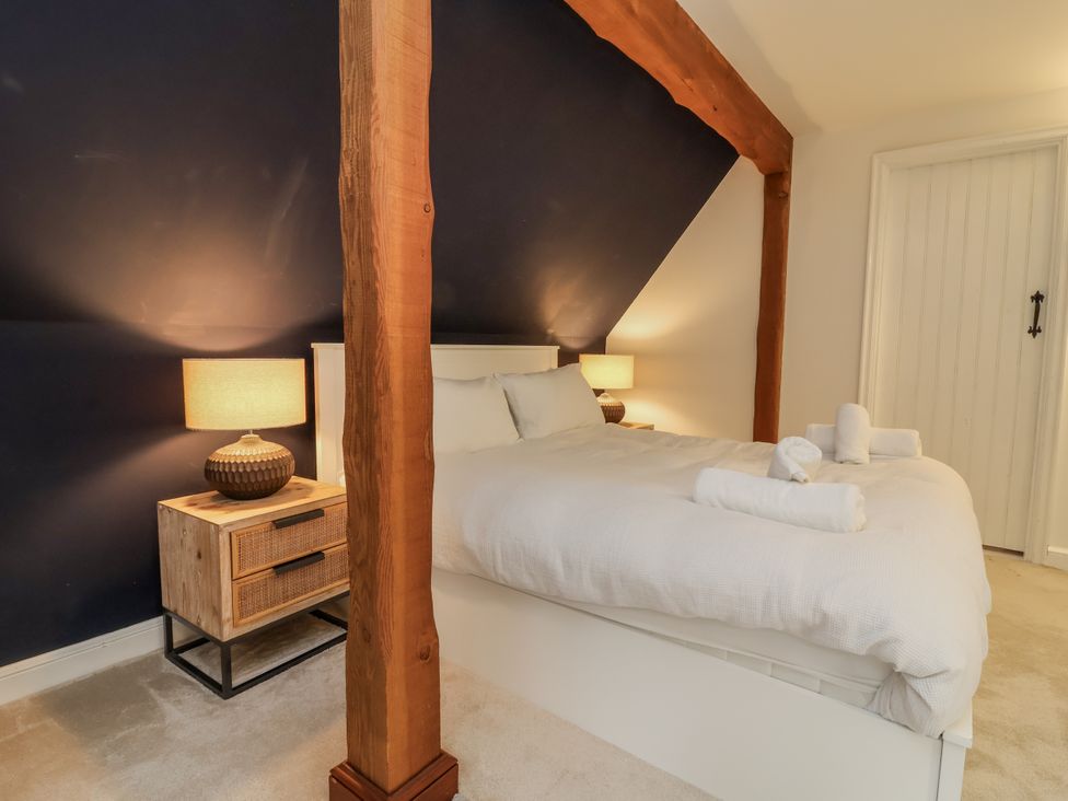 A bedroom with a bed and nightstand at Hedgerose Goodleigh near Barnstaple