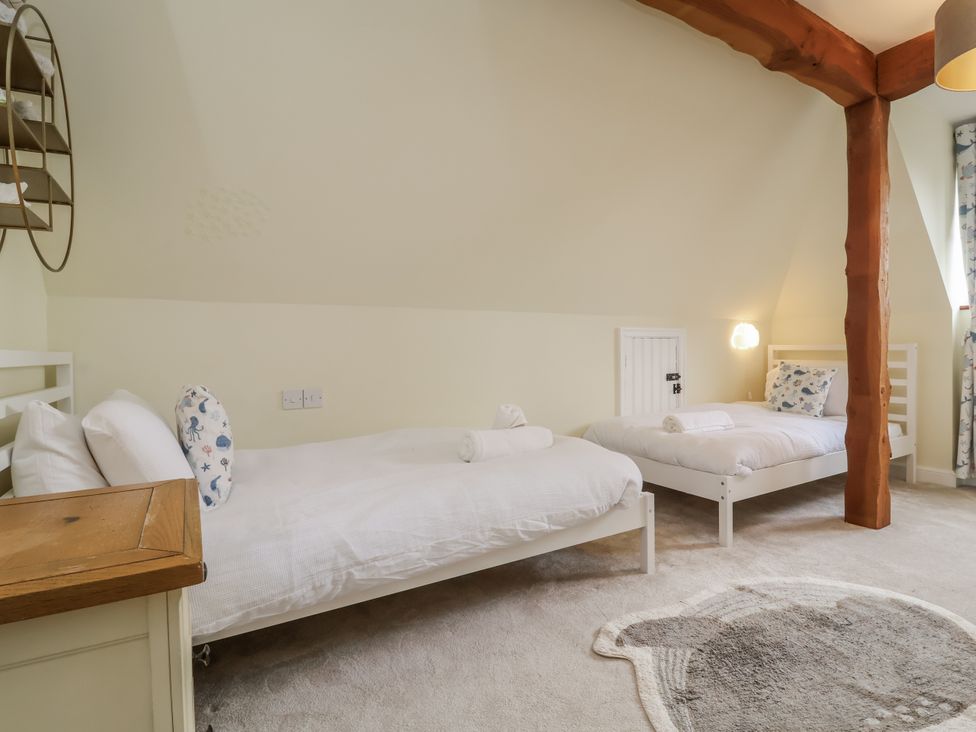 A bedroom with two beds and shelves at Hedgerose in Goodleigh near Barnstaple