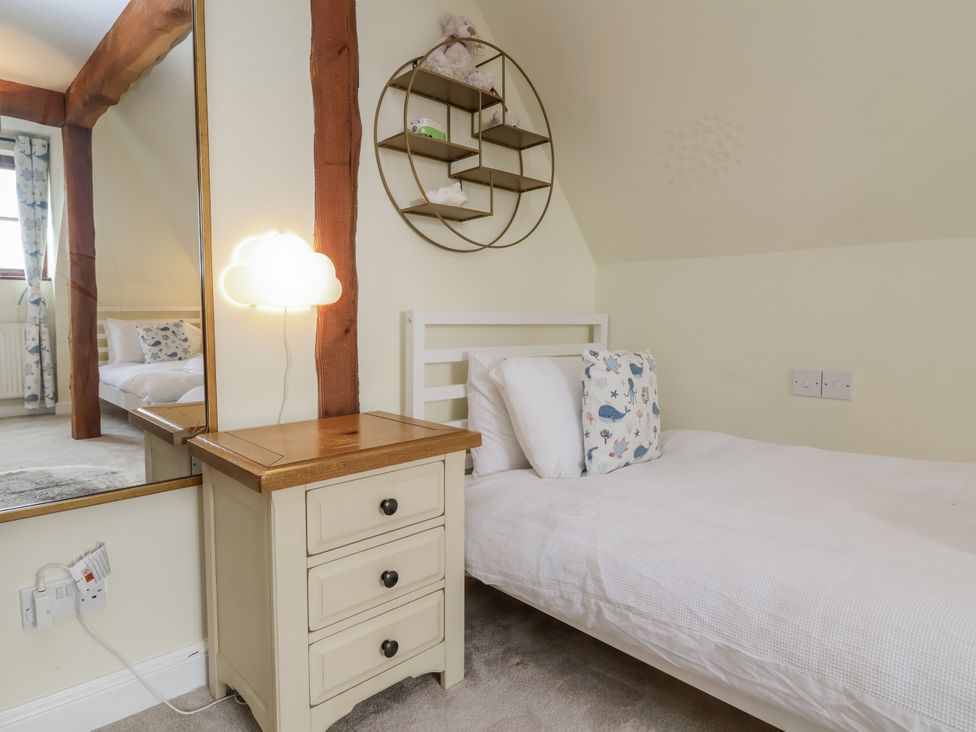 A bedroom with a single bed and lamp at Hedgerose in Goodleigh near Barnstaple