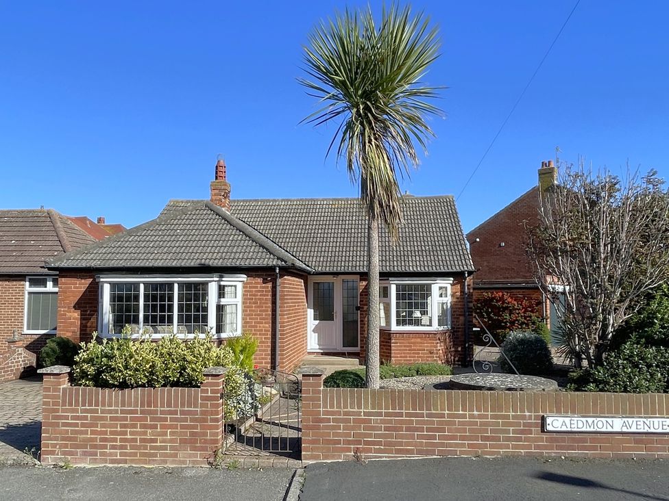 A bungalow with a palm tree on Caedmon Avenue in Whitby