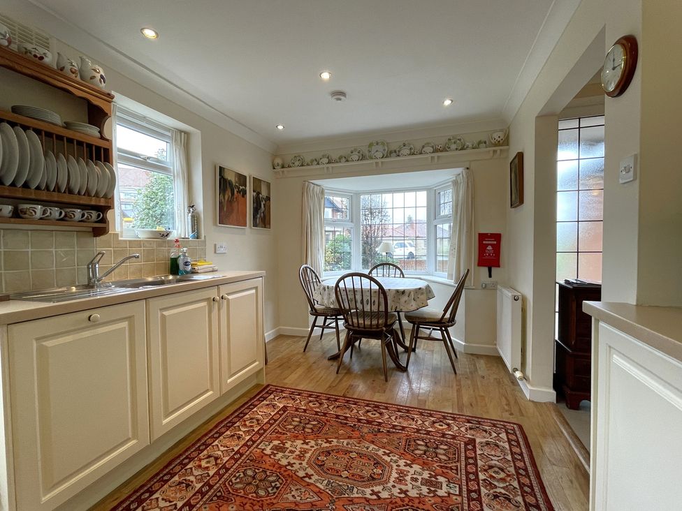 A kitchen with a dining area and window at Roseberry in Whitby