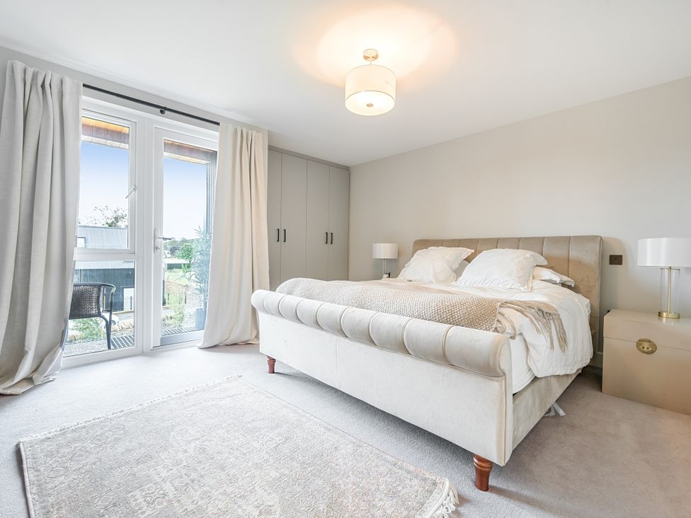 A bedroom with a bed and wardrobe at The Old Barn in Manchester