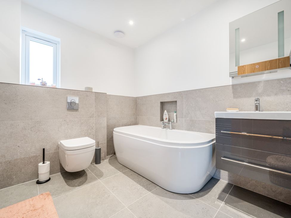 A bathroom with a bathtub, toilet, and sink