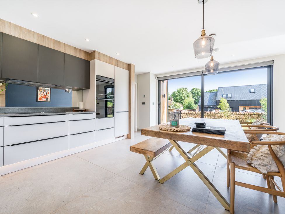 A kitchen with a dining area featuring a table and chairs at 3 Fallow Gardens near Lazonby