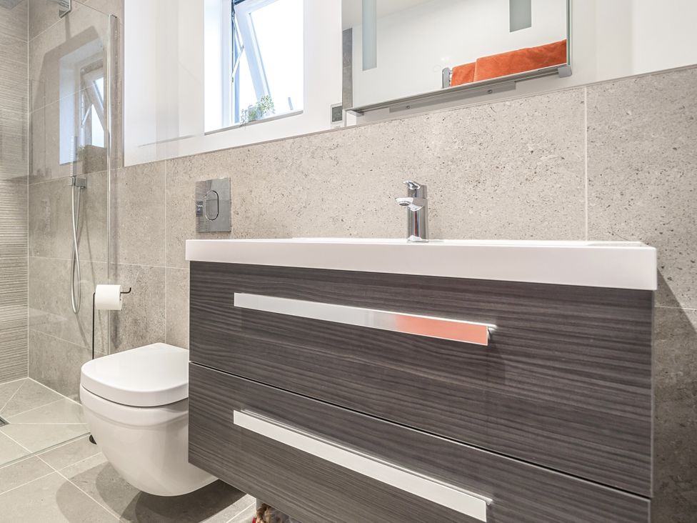 A bathroom with a sink, toilet and shower at 3 Fallow Gardens Great Salkeld near Lazonby
