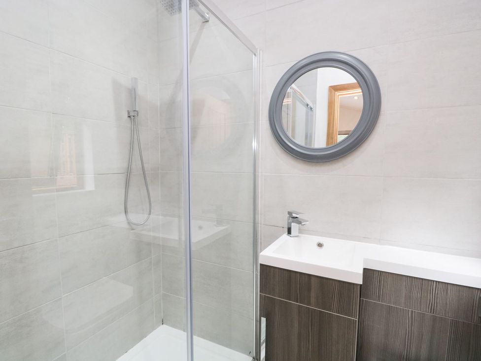A bathroom with a shower and sink at Easedale Lodge Waterside Wood 2, White Cross Bay near Windermere