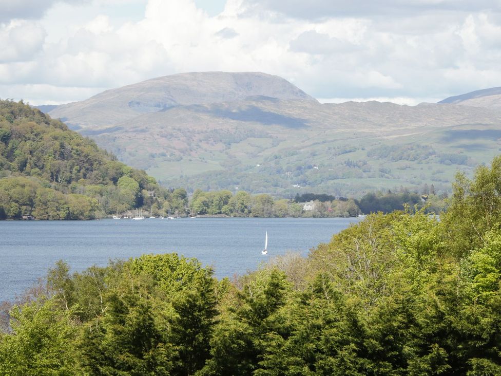 A view of a lake with trees and mountains at Easedale Lodge in Waterside Wood 2, White Cross Bay near Windermere