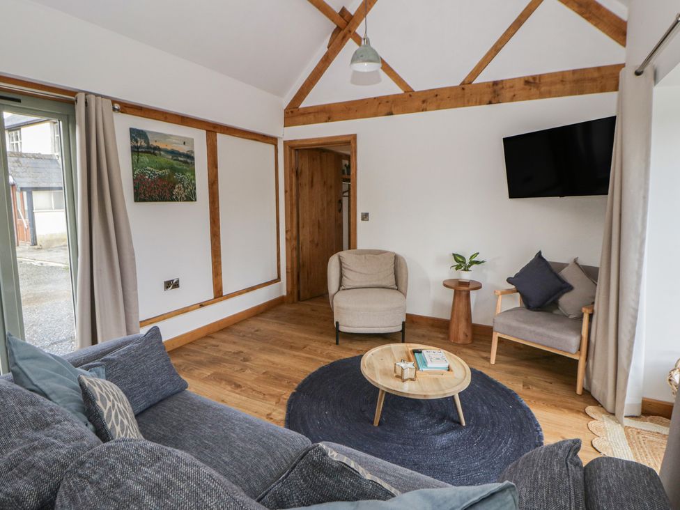 A living room with a sofa and coffee table at Eleri’s Barn Nantmel near Rhayader