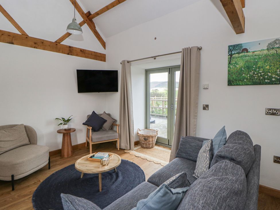 A living room with a sofa and coffee table at Eleri’s Barn Nantmel near Rhayader