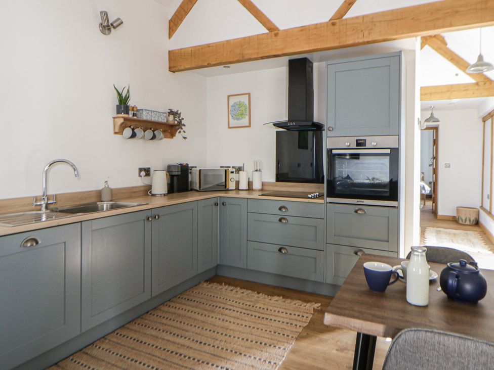 A kitchen with cabinets and appliances at Eleri’s Barn Nantmel near Rhayader