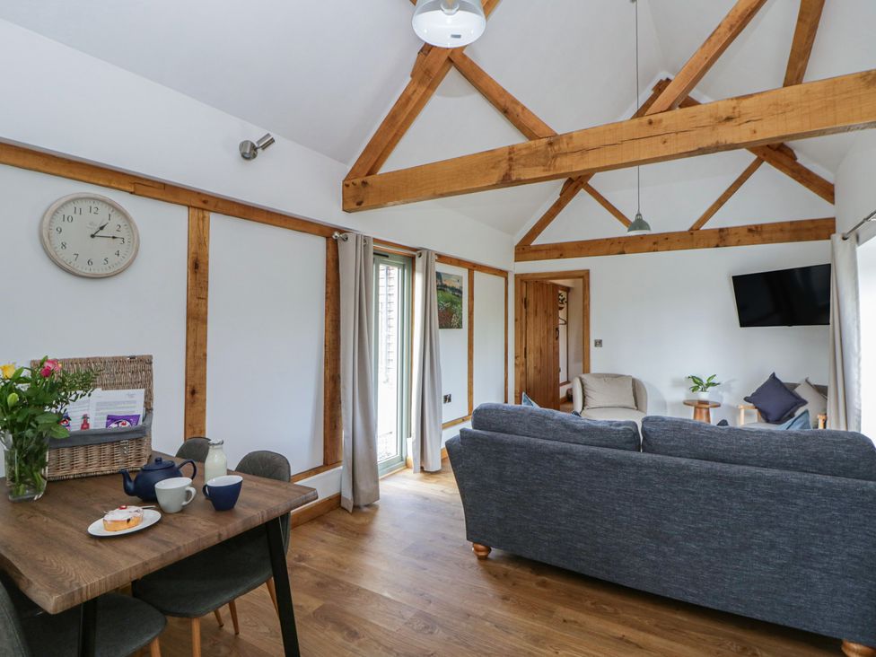 A living room with a table and chairs at Eleri’s Barn Nantmel near Rhayader