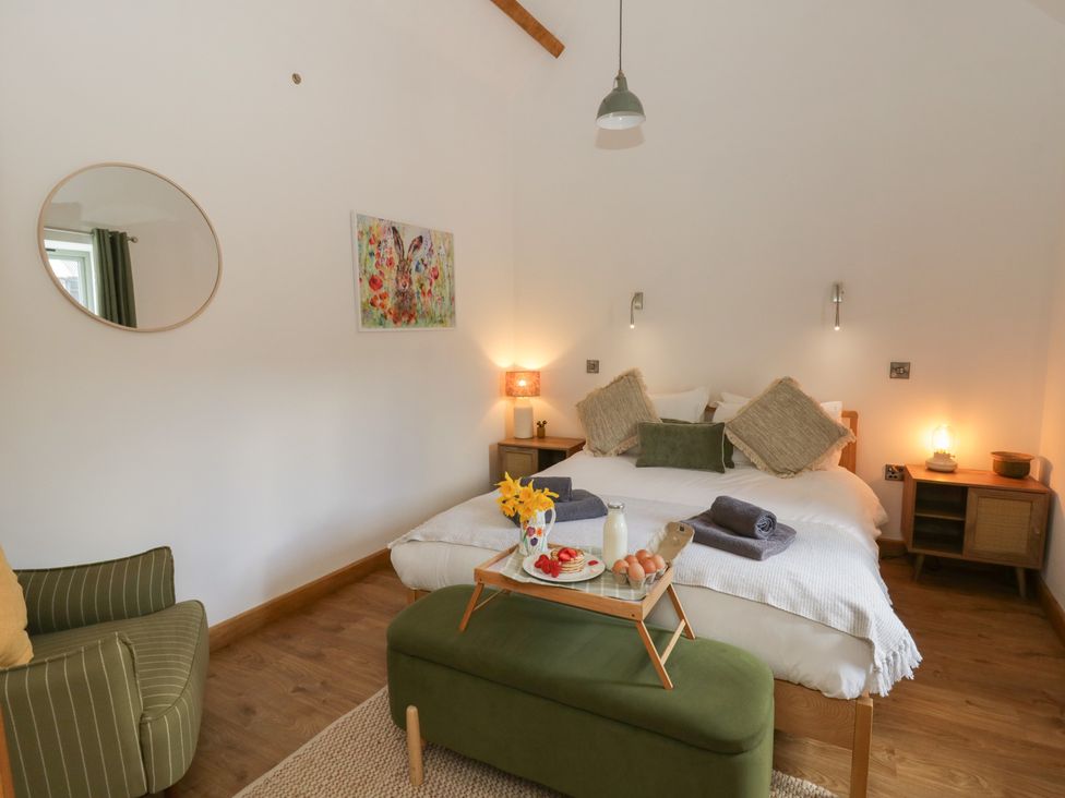 A bedroom with a bed and side tables at Eleri’s Barn Nantmel near Rhayader