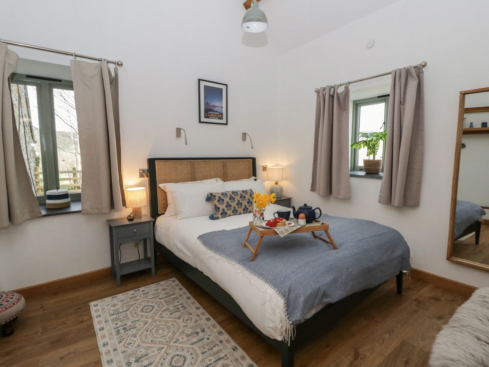 A bedroom with a bed and a tray on it at Eleri’s Barn Nantmel near Rhayader