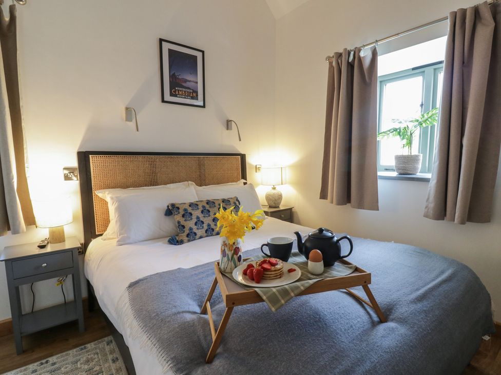 A bedroom with a bed and breakfast tray at Eleri’s Barn Nantmel near Rhayader