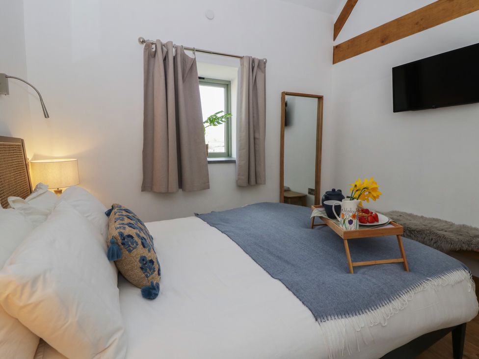 A bedroom with a bed and a tray on it at Eleri’s Barn Nantmel near Rhayader