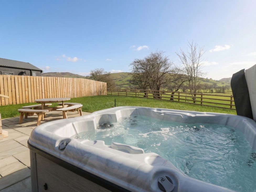 A hot tub and seating area at Daverneithon 1 Near Llandrindod Wells