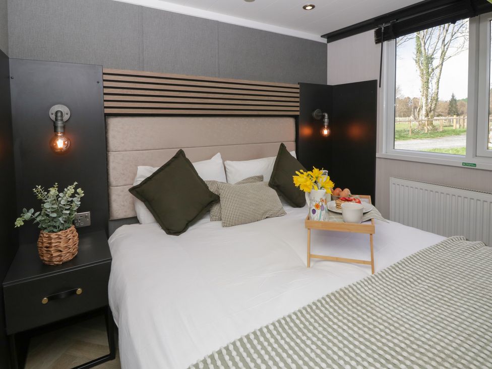 A bedroom with a bed and decorative items at Daverneithon 1 Near Llandrindod Wells