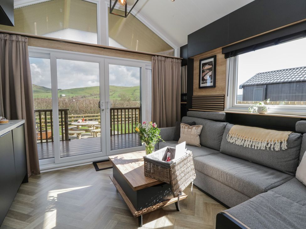 A living room with a sofa and a table at Daverneithon 2 near Llandrindod Wells