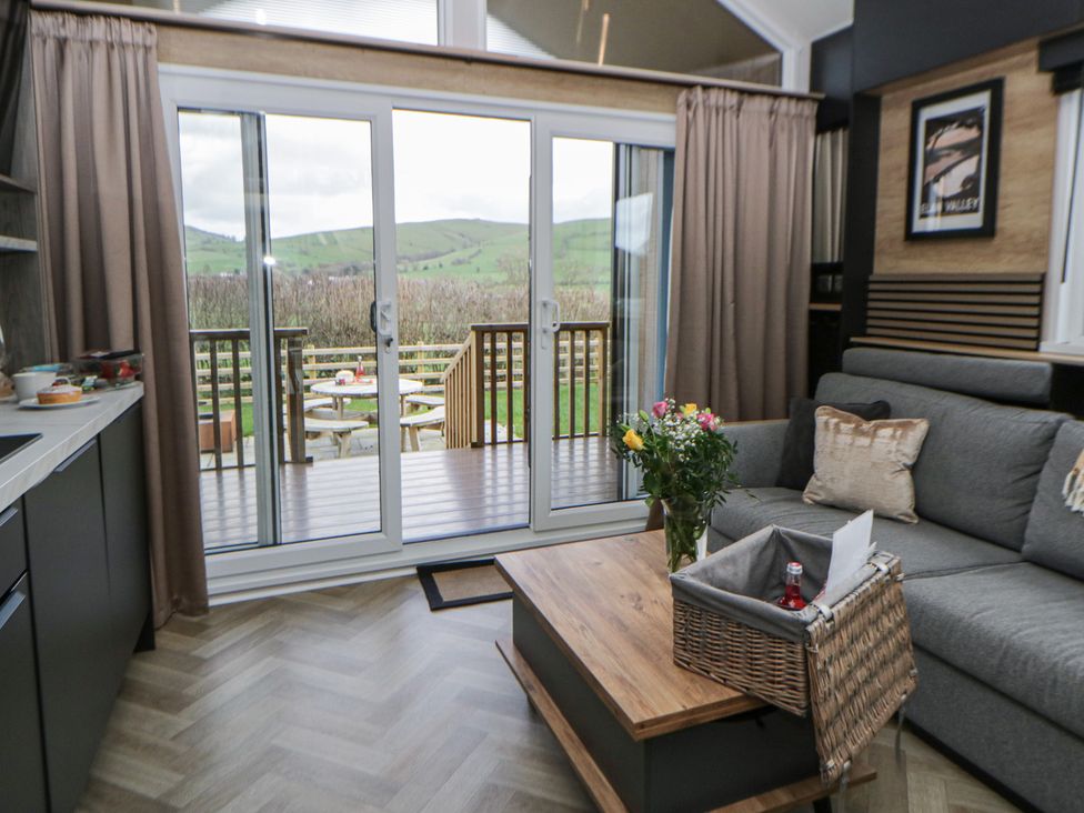 A living room with a sofa and sliding doors at Daverneithon 2 near Llandrindod Wells