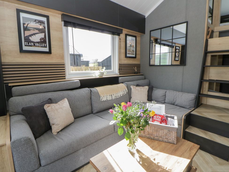 A living room with a sofa and a table at Daverneithon 2 near Llandrindod Wells